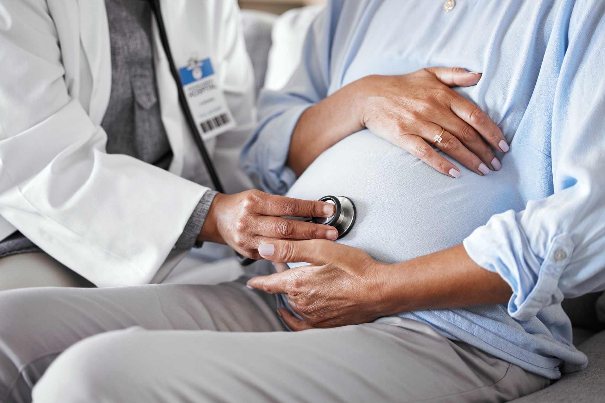Pregnant, mother stomach and doctor with stethoscope, healthcare and checkup. Pregnancy, female and