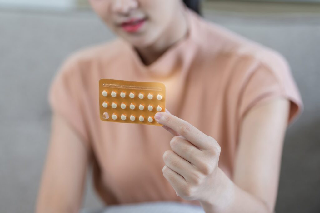 Young Woman Holding Birth Control Pill Pack, Close-Up of Hand and Medication, Contraceptive Health